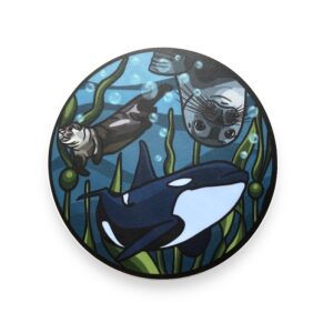 Circle vinyl sticker with a sea otter, seal, and orca whale swimming together
